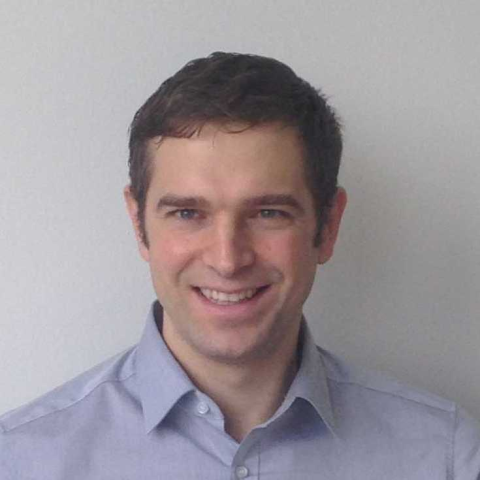 headshot of Matthias Nießner from the shoulders up, wearing a light indigo collared shirt and smiling