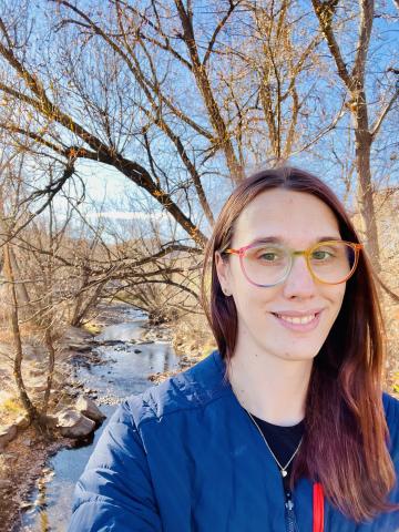 photo of Charlie, wearing a blue sweater and gold rimmed glasses